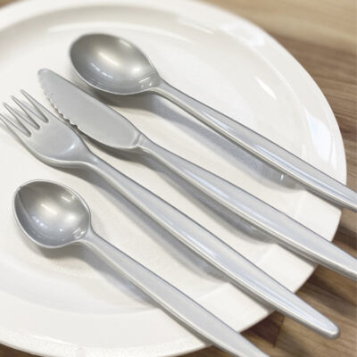 Grey coloured cutlery on plate